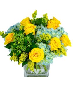 Seaside Blooms of yellow, blue, and green in modern square shaped vase