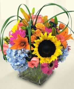sunflower and various orange and pink flower arrangement