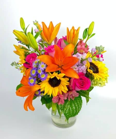 Send the joy that garden blooms bring with this colorful cylinder of sunflowers, mini green hydrangea, roses, alstroemeria and more!