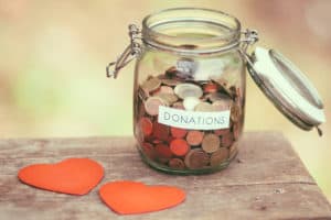Coin donation jar with red hearts